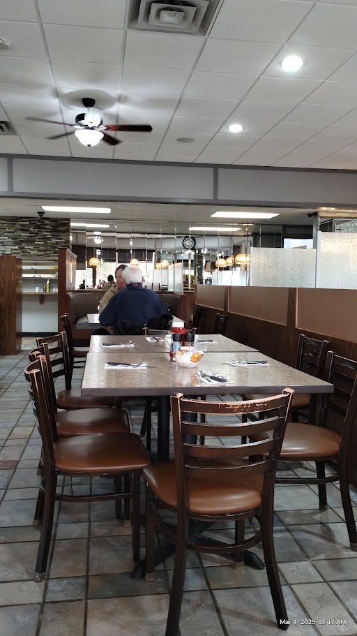 Spacious diner seating under soft overhead lights.