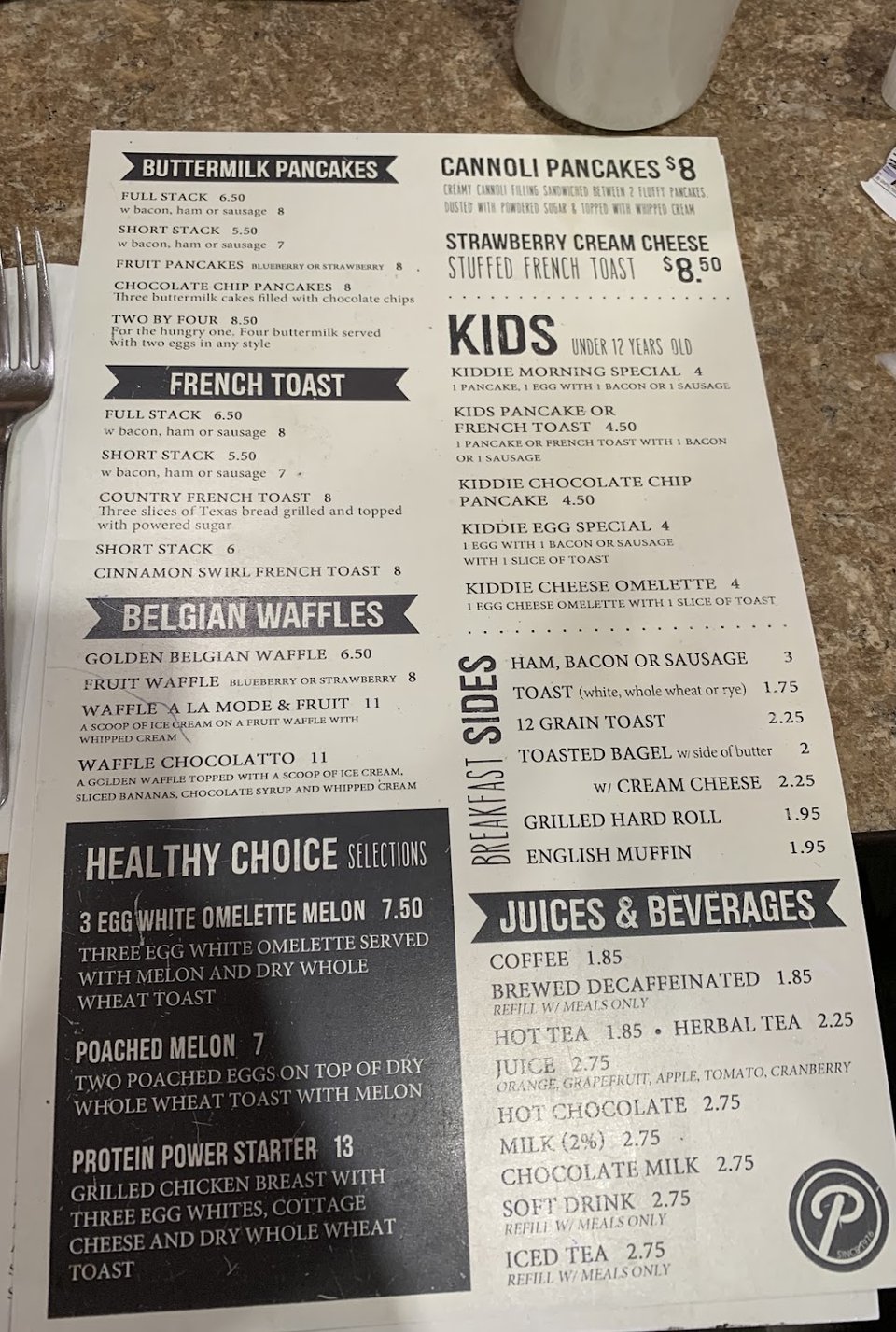 Breakfast menu pages on a restaurant table.
